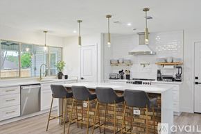 Irving house for rent - A kitchen with white cabinets and a white counter top.