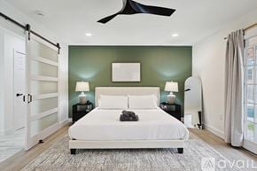 Irving house for rent - A bedroom with a white bed and a ceiling fan.