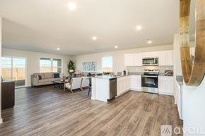 Bullhead City house for rent - A modern kitchen with white cabinets and a wooden floor.