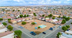 Bullhead City house for rent - A bird's eye view of a residential area with houses, cars, and a playground.