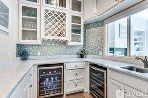 Lakewood Village house for rent - A kitchen with white cabinets and a tile backsplash.