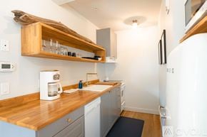 New Castle apartment for rent - A kitchen with a wooden counter top and a white coffee maker.