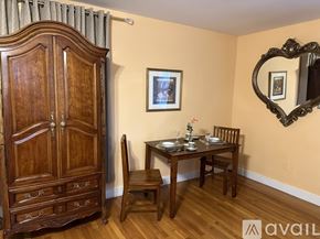 Gordonsville apartment for rent - A wooden dining table with chairs and a cabinet in a room.