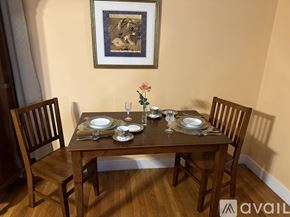 Gordonsville apartment for rent - A dining table set with plates and glasses with a painting hanging on the wall.