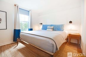 New Castle apartment for rent - A bedroom with a bed, nightstand, and window.