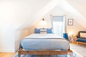 New Castle apartment for rent - A bedroom with a bed and a chair.