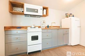 New Castle apartment for rent - A kitchen with a white refrigerator, a white oven, and a white microwave.