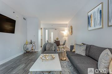 San Diego condo for rent - A modern living room with a grey sofa and a white coffee table.
