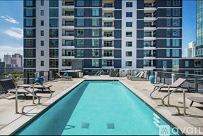 San Diego condo for rent - A large swimming pool in front of a tall building.