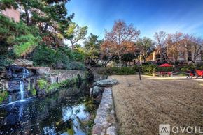 Irving apartment for rent - A beautiful garden with a waterfall and a red umbrella.