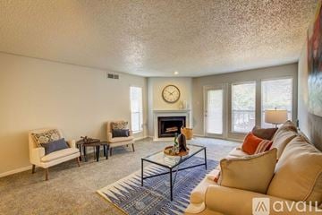 Irving apartment for rent - A living room with a fireplace and a large painting on the wall.