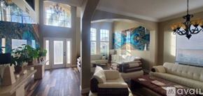 Daytona Beach apartment for rent - A large peacock mural is the centerpiece of this well-lit room.