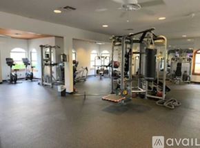 Daytona Beach apartment for rent - A large outdoor swimming pool surrounded by palm trees.