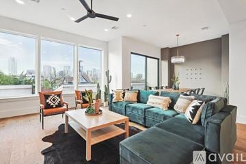 Dallas townhouse for rent - A living room with a green couch and a wooden coffee table.