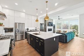 Dallas townhouse for rent - A modern kitchen with a large island and stainless steel appliances.