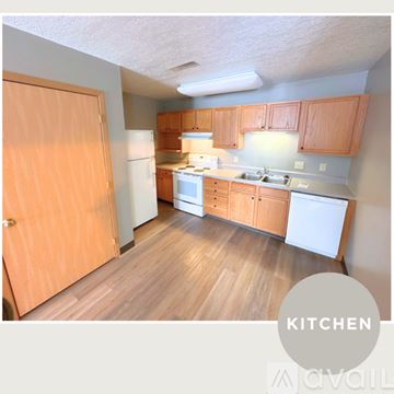 Spencer apartment for rent - A kitchen with wooden floors and cabinets.