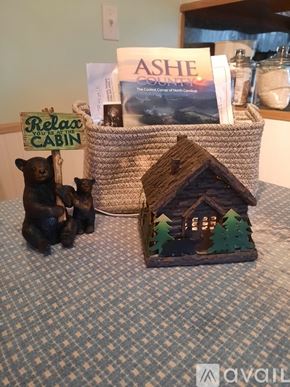 Warrensville house for rent - A small house with trees and a bear figurine sits on a table.