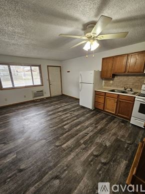 La Crosse apartment for rent - A kitchen with wooden floors and white appliances.