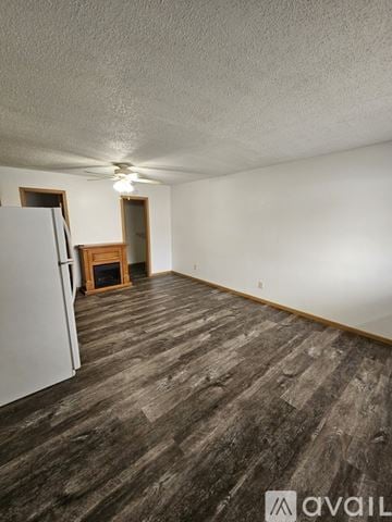 La Crosse apartment for rent - A kitchen with wooden cabinets and a stone backsplash.