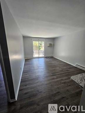 Chester apartment for rent - A room with wooden floors and a door leading outside.