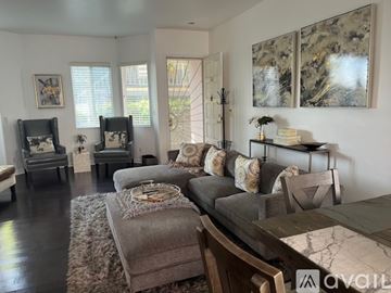Inglewood condo for rent - A living room with a grey couch and a wooden table.
