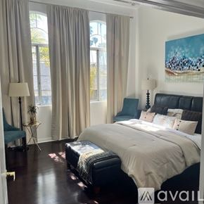 Inglewood condo for rent - A bedroom with a large bed and a painting on the wall.