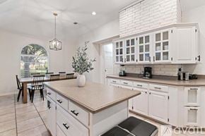 North Richland Hills house for rent - A kitchen with white cabinets and a large island.