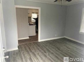 Rockford apartment for rent - A room with a wooden floor and a ceiling fan.