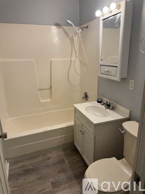 Rockford apartment for rent - A bathroom with a toilet, sink, and bathtub.