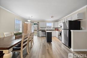 Winston-Salem apartment for rent - A kitchen with a wooden table and chairs is available for rent.
