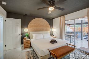 Houston house for rent - A bedroom with a large bed and a ceiling fan.