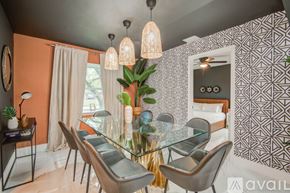 Houston house for rent - A modern dining room with a glass table and chairs.