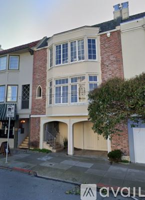 San Francisco apartment for rent - A two-story building with a brick chimney and a balcony.