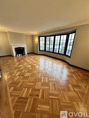 San Francisco apartment for rent - A room with a fireplace and a large window.