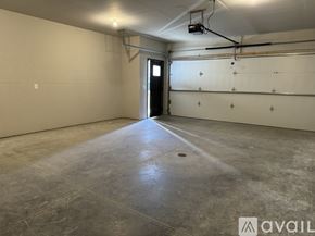 North Mankato townhouse for rent - A spacious empty room with a door and a window.