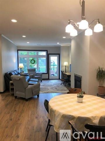 North Mankato townhouse for rent - A living room with a dining table set up with a plant on it.