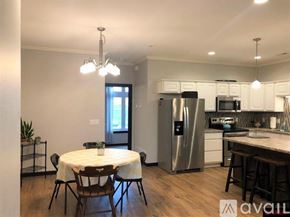 North Mankato townhouse for rent - A kitchen with a table and chairs in the middle of the room.