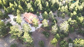 Westcliffe house for rent - A house surrounded by trees in an aerial view.