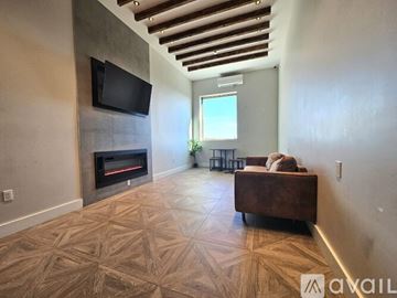 East Orange apartment for rent - A living room with a fireplace and a television mounted on the wall.