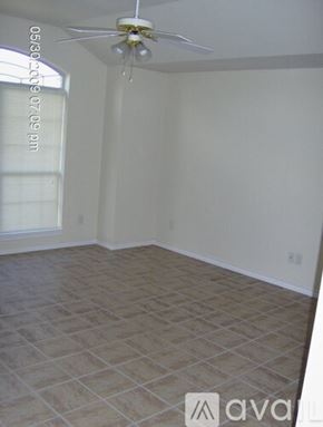 College Station townhouse for rent - A room with a tiled floor and a ceiling fan.
