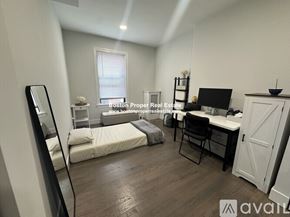 Boston apartment for rent - A bedroom with a bed, desk, and chair is available for rent.