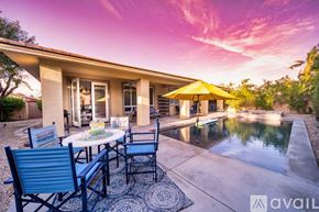 Rancho Mirage house for rent - A patio with a table set for two and a pool in the background.