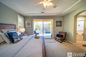 Rancho Mirage house for rent - A bedroom with two beds and a ceiling fan.