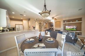 Rancho Mirage house for rent - A dining room with a table set for two and a television in the background.