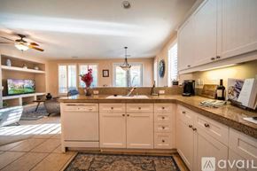 Rancho Mirage house for rent - A kitchen with white cabinets and a tiled floor.