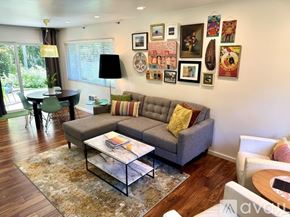 Manzanita house for rent - A modern kitchen with white cabinets and a TV mounted above the counter.