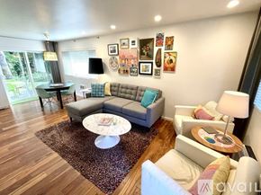 Manzanita house for rent - A living room with a grey couch, a white armchair, and a coffee table.