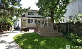 Cleveland Heights house for rent - A house with a green lawn and trees around it.