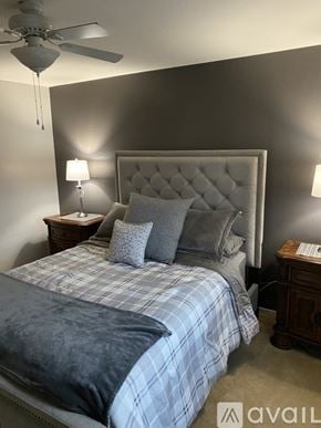 Surprise house for rent - A bedroom with a large bed and a ceiling fan.