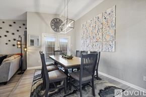 Garland house for rent - A dining room with a table set for four and a large painting on the wall.